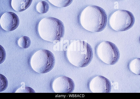 Water drops on purple abstract background, top view Stock Photo