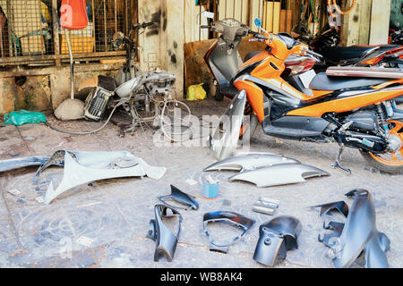 Replacement parts for motorbikes in street repair center in Ho Chi Minh city in Vietnam in Asia. Supplement spare details for Motorcycles and mopeds. Stock Photo