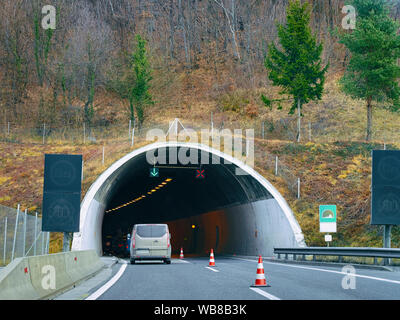 Car in the road driving from the tunnel in the mountains in Slovenia. Travel in Europe Stock Photo