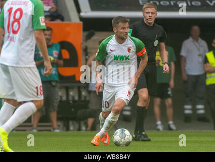 Augsburg, Germany. 24th Aug, 2019. Soccer: Bundesliga, FC Augsburg - 1st FC Union Berlin, 2nd matchday in the WWK-Arena. Augsburg's Daniel Baier plays the ball. Credit: Stefan Puchner/dpa - IMPORTANT NOTE: In accordance with the requirements of the DFL Deutsche Fußball Liga or the DFB Deutscher Fußball-Bund, it is prohibited to use or have used photographs taken in the stadium and/or the match in the form of sequence images and/or video-like photo sequences./dpa/Alamy Live News Stock Photo