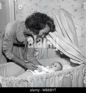 Motherhood in the 1950s. A mother is cuddling with her baby at home.  Sweden 1955. Kristoffersson ref BT40-4 Stock Photo