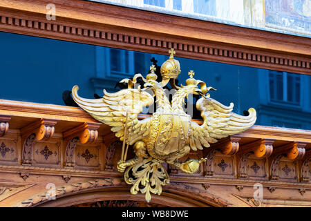 Golden coat of arms of Austria-Hungary in Old city of Graz in Austria. Heraldic symbol of Astro-Hungarian empire in Styria in Europe. Two headed eagle Stock Photo
