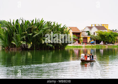 Landscape with boat on river and riverfront in Street in Old city of Hoi An in Southeast Asia in Vietnam. Vietnamese heritage and culture in Hoian. Tr Stock Photo