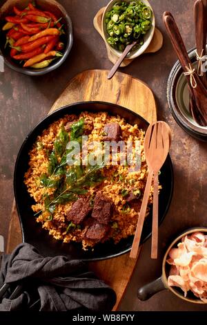 Nasi Goreng Rendang. Indonesian fried rice with Beef Rendang and its spice mix Stock Photo