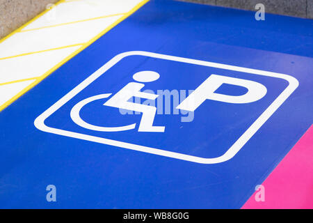 wheelchair parking sign or handicapped parking sign and symbols for warning motorists Stock Photo