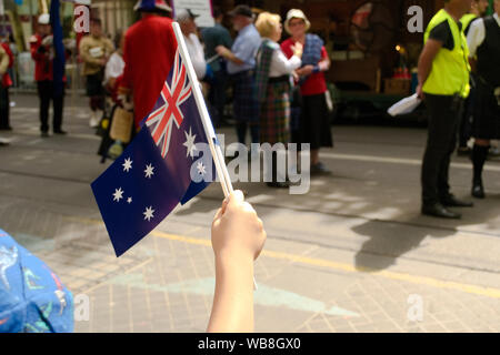 Australia Day in Melbourne - January 26, 2019. Child waving Australian Flag during parade Stock Photo