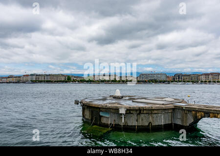 The white nozzle is the base of the famous water jet, a landmark of Lake Geneva in the city in the background. This day it was switched off. Stock Photo