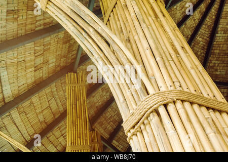 Many bamboo bindings are tied together with hemp ropes to be used as pole for resting cottage. Selective focus on hemp ropes. Stock Photo