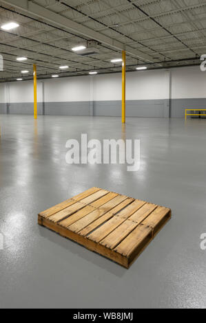 Empty Pallet In Large Warehouse, USA Stock Photo