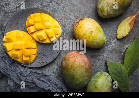 Fresh mango tropical fruits over gray background, top view with Copy space. Stock Photo