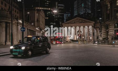 London streets at night near Bank of England building with passing transport Stock Photo