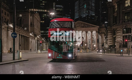 London streets at night near Bank of England building with passing transport Stock Photo