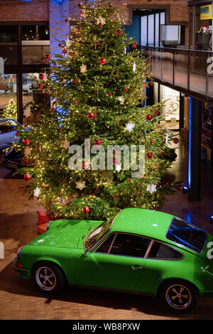 Berlin, Germany - December 11, 2017: Green vintage classic Porsche car in Berlin of Germany. Details of auto. Christmas tree on the background Stock Photo
