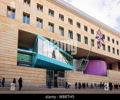Berlin, Germany - December 8, 2017: People passing by  at British Embassy building with UK flag in Berlin Mitte, Germany Stock Photo
