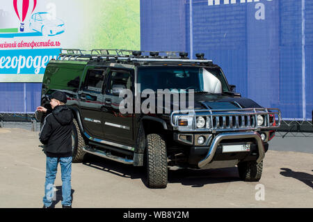 Firm 'Nizhegorodets.' A three-axle, black, chrome-plated Hummer car, stands near the salon. Russia Stock Photo
