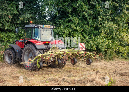 English farm tractor turning grass Stock Photo