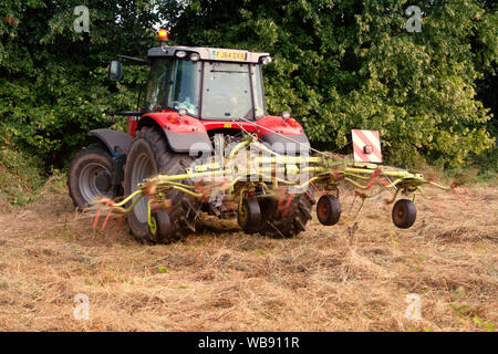 English farm tractor turning grass Stock Photo