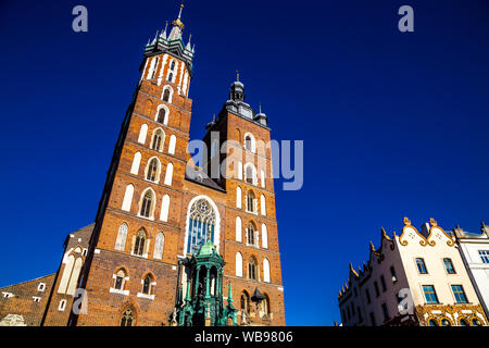 St. Mary's Basilica (Kościół Mariacki) in the Main Square (Rynek Glowny) of Krakow, Poland Stock Photo