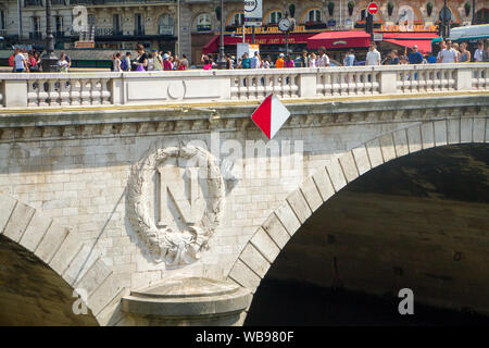 Paris, France - July 07, 2018: Pont Neuf Bridge with lots of people walking and art deco building in the background Stock Photo