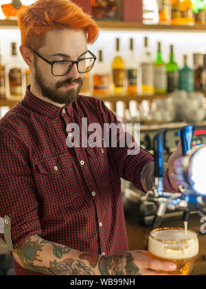 Manager pouring a beer in the Dom bar in Minsk, Belarus. Stock Photo