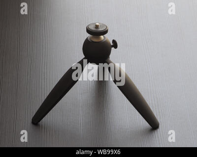 Compact tripod for cameras on the table. Stock Photo