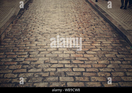 Closeup of a cobblestone street on a rainy day in Seville, Andalusia, Spain Stock Photo