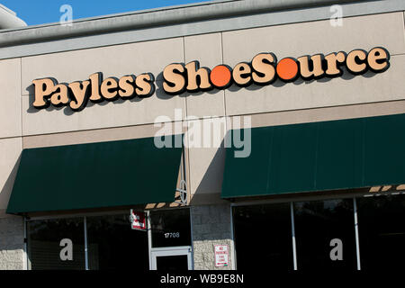A logo sign outside of an abandoned Payless ShoeSource retail store location in Hagerstown, Maryland on August 8, 2019. Stock Photo