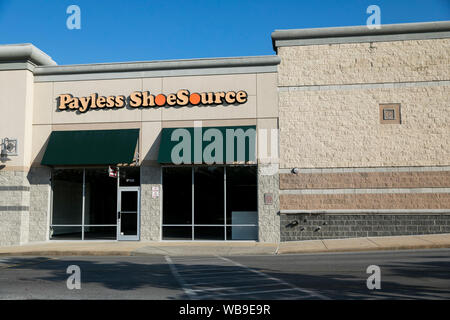 A logo sign outside of an abandoned Payless ShoeSource retail store location in Hagerstown, Maryland on August 8, 2019. Stock Photo