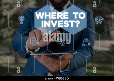 Handwriting text writing Where To Invest Question. Conceptual photo asking about where put money into financial schemes or shares Male human wear form Stock Photo