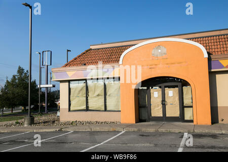 The faded outline of a logo sign outside of a closed and abandoned Taco Bell fast food restaurant location in Bridgeville, Pennsylvania on August 9, 2 Stock Photo