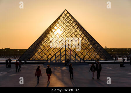 PARIS, FRANCE - MAY 4, 2018: The famous Louvre Pyramid illuminated at sunset. Stock Photo