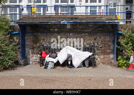 A person sleeping rough on seafront promenade belongings in a Stock ...