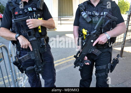 Two Greater Manchester Police officers carry Heckler & Koch rifles to help safeguard thousands of festival goers at Manchester Pride Live to see Ariana Grande and other performers. The concert at the Mayfield Depot site, near Piccadilly Railway station, is part of Manchester, uk, LGBT Pride. Stock Photo