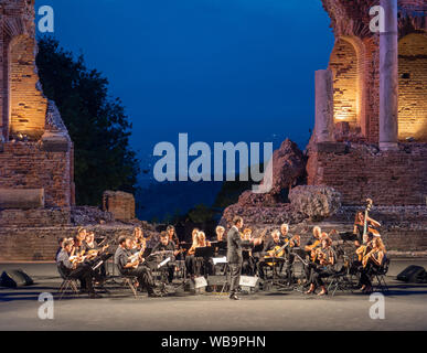 A mandolin orchestra plays in the Taetro Antico di Taormina, Sicily Stock Photo