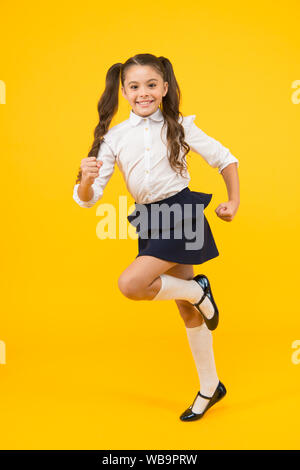 Keep going. Active child in motion. Freedom concept. Knowledge determined success. Active kid. Girl on way knowledge. Knowledge day. Back to school. Kid cheerful schoolgirl running. Pupil want study. Stock Photo
