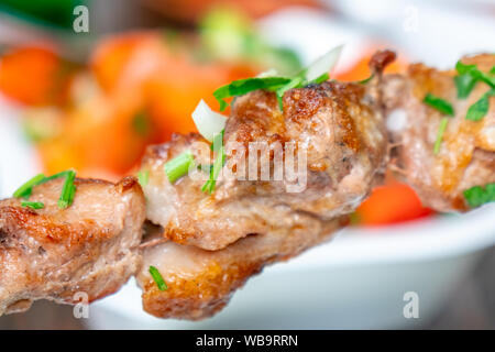 Grilled Kebab or Barbecue Shashlik (mtsvadi) on a Skewer. Macro Photo of Skewered Grilled Cubes of Meat with Selective Focus. food. Stock Photo