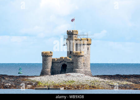 The Tower of Refuge on St Mary's Isle in Douglas Bay, Isle of Man, was built in 1832 to provide shelter for mariners wrecked on the reef. Stock Photo