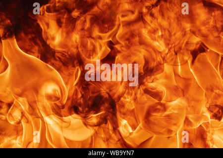 Abstract red fire natural texture with blaze. Beautiful dangerous firestorm abstract background. Atmospheric dispersion, defocus (soft focus), motion Stock Photo