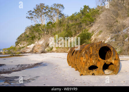 Abandoned steam boiler on beach, one of the few reminders of the once busy timber centre at McKenzies Jetty. North White Cliffs, Fraser Island, Queens Stock Photo