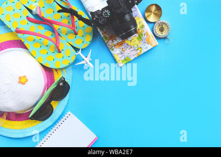 Travel background concept / Planning Essential vacation trip items summer travel accessories with camera sunglasses hat flip flops compass map noteboo Stock Photo