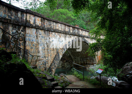 Stone Roman arch bridge, built over Little Crystal Creek, Paluma Range National Park, North Queensland, Australia. Stock Photo