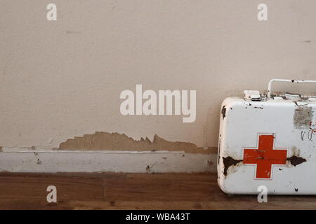 vintage first aid kit from the 1950s that is beaten up and rusty. Stock Photo