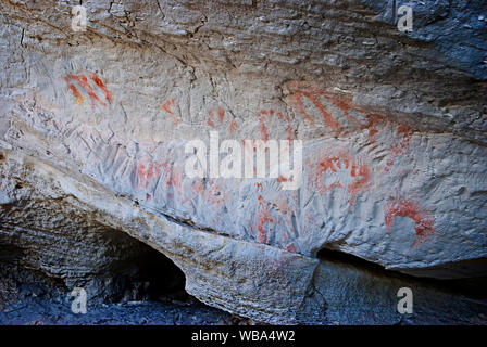 Stencilled hands at the Tombs, a sacred area used as a burial site by the Aboriginal inhabitants of the region.   Vandals and grave robbers had desecr Stock Photo