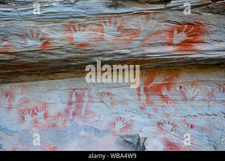 Stencilled hands at the Tombs, a sacred area used as a burial site by the Aboriginal inhabitants of the region.   Vandals and grave robbers had desecr Stock Photo