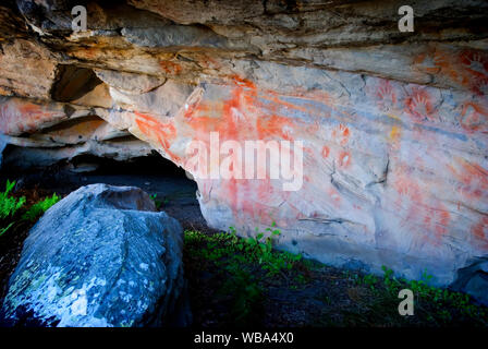 Rock art at the Tombs, a sacred area used as a burial site by the Aboriginal inhabitants of the region.   Vandals and grave robbers had desecrated the Stock Photo