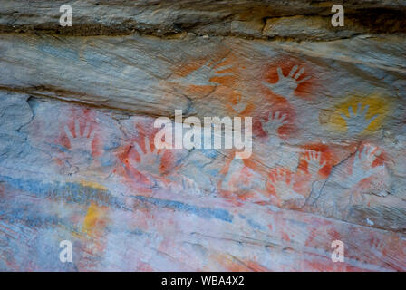 Stencilled hands at the Tombs, a sacred area used as a burial site by the Aboriginal inhabitants of the region.   Vandals and grave robbers had desecr Stock Photo