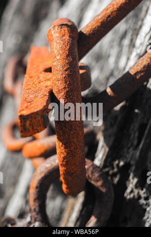 Vertical selective closeup shot of a heavy red chain Stock Photo