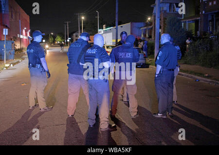 Group of Detroit police Special Ops officers stand in a street, trying to clear it of people, Detroit, Michigan, USA Stock Photo