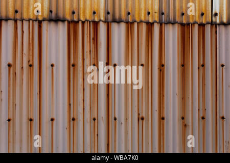 A corrugated tin wall with rust streaks on it in Yamato, Kanagawa, Japan. Stock Photo
