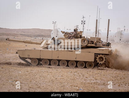 190814-M-ET529-1019 CAMP BUEHRING, Kuwait (Aug. 14, 2019) Marines assigned to India Company, Battalion Landing Team 3/5, 11th Marine Expeditionary Unit (MEU), operate an M1A1 Abrams tank at Camp Buehring, Kuwait. The Boxer Amphibious Ready Group and 11th MEU are deployed to the U.S. 5th Fleet area of operations in support of naval operations to ensure maritime stability and security in the Central Region, connecting the Mediterranean and the Pacific through the Western Indian Ocean and three strategic choke points. (U.S. Marine Corps photo by Cpl. Israel Chincio/Released) Stock Photo